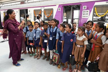 NAVI MUMBAI, INDIA - JANUARY 12: Zilla Parishad School children and teachers were brought to see train ahead of PM visit at  on January 12, 2024 in Navi Mumbai, India.  clipart