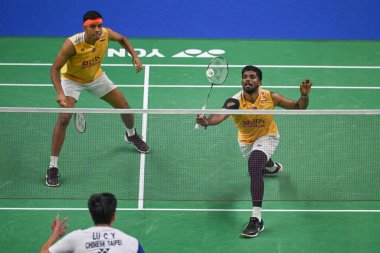 NEW DELHI, INDIA - JANUARY 18, 2024: Satwiksairaj Rankireddy with Chirag Shetty from India competes during the Mens doubles match against Lu Ching Yao with Yang Po Han of Taiwan at the Yonex-Sunrise India Open 2024 badminton tournament   clipart