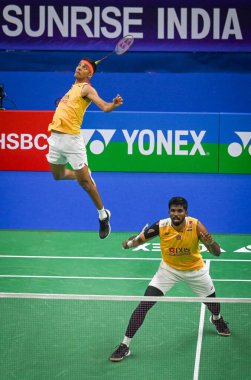 NEW DELHI, INDIA - JANUARY 18, 2024: Satwiksairaj Rankireddy with Chirag Shetty from India competes during the Mens doubles match against Lu Ching Yao with Yang Po Han of Taiwan at the Yonex-Sunrise India Open 2024 badminton tournament   clipart