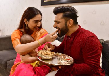 MUMBAI, INDIA - JANUARY 13, 2024: Bollywood singer Rahul Vaidya and his wife, actor Disha Parmar Vaidya pose during an exclusive interview with HT City for Makar Sankranti festival special shool clipart