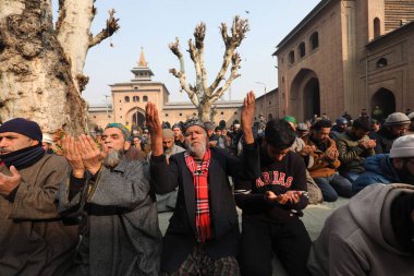 SRINAGAR, INDIA - JANUARY 12, 2024:  People offer Salat al-Istisqa prayers after the Friday prayers in the compound of Jamia Masjid or Grand Mosque  clipart