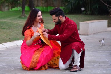 MUMBAI, INDIA - JANUARY 13, 2024: Bollywood singer Rahul Vaidya and his wife, actor Disha Parmar Vaidya pose during an exclusive interview with HT City for Makar Sankranti festival special shool clipart