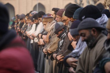 SRINAGAR, INDIA - JANUARY 12, 2024:  People offer Salat al-Istisqa prayers after the Friday prayers in the compound of Jamia Masjid or Grand Mosque  clipart