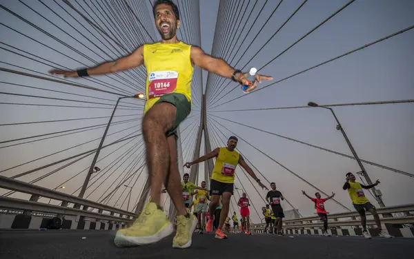 stock image Mumbai, India - Jan. 21, 2024: Participants run on Bandra-Worli sea link bridge as they take part in a marathon on January 21, 2024 in Mumbai, India.