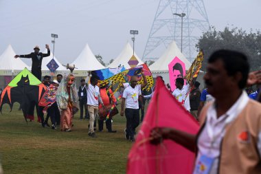 NEW DELHI, INDIA JANUARY 13, 2024: İlk uluslararası uçurtma festivalinde insanlar uçurtma uçuruyor- Patang Utsav Baansera 'da Delhi LG VK Saxena' nın açılışında, Sarai Kale Khan nehrinin kıyısındaki ilk bambu temalı parkı