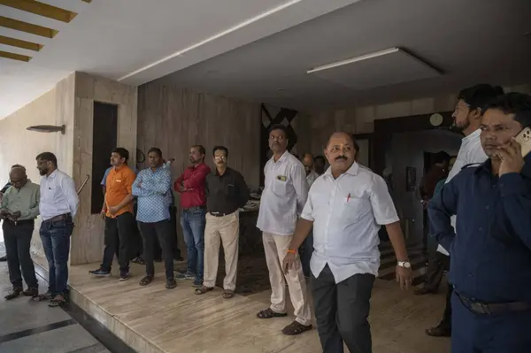 stock image MUMBAI, INDIA - JANUARY 9: Supporters are sitting out side the Shiv Sena UBT group MLA Ravindra Waikar, residence, Jogeshwari during ED searches premises of SS (UBT) MLA Ravindra Waikar over money laundering charges  on January 9, 2024 in Mumbai