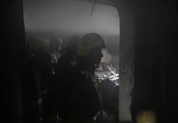 stock image NOIDA, INDIA  JANUARY 14, 2024: A team of Firefighters trying to extinguish a fire gutted inside a house along with rescuing three people in Sector 25