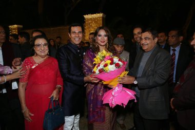 NEW DELHI, INDIA  DECEMBER 15, 2023: Union Road Transport and Highways Minister Nitin Gadkari with Bollywood actor Randeep Hooda and his wife Lin Laishram during their wedding reception party, on  December 15, 2023 in New Delhi, India. clipart