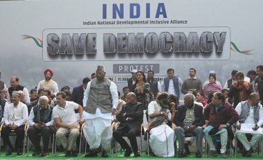 NEW DELHI, INDIA - DECEMBER 22, 2023: Congress President Mallikarjun Kharge with party leaders Rahul Gandhi and K.C. Venugopal, CPI(M) General Secretary Sitaram Yechury and NCP chief Sharad Pawar during a protest. clipart