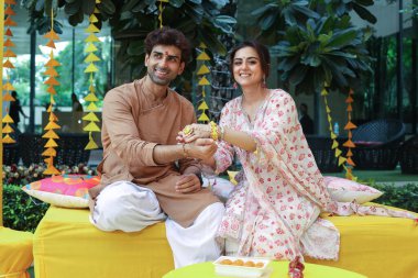 NEW DELHI, INDIA  AUGUST 28, 2024: Indian actors Ridhi Dogra and Akshay Dogra celebrate Raksha Bandhan during an exclusive interview with HT City for Rakhi festival special shoot clipart