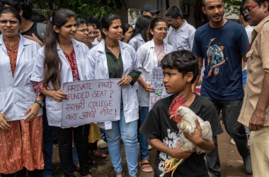 MUMBAI, INDIA - AUGUST 6: Jilani Shaikh took the chicken to Goregaon Veterinary OPD for treatment, but it returned home untreated due to strike by the students of Mumbai Veterinary College on August 6, 2024 in Mumbai, India.  clipart