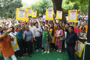 NEW DELHI, INDIA - AUGUST 8:  Delhi University teachers sit on dharna at Jantar Mantar for their demands including privatization of education, implementation of old pension scheme, creation of posts of teachers after increasing EWS reservation    clipart