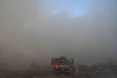 NEW DELHI, INDIA 19 Mayıs: 30. Sektör 'deki boş bir arsada meydana gelen yangın, Perşembe akşamı boyunca yanmaya devam ederek yakınlardaki bölge sakinlerini boğulma ve gözlerinde yanma hissi bıraktı.