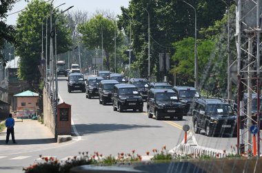 SRINAGAR, INDIA - MAY 22, 2023:  A motorcade of G20 delegates moves through city clipart