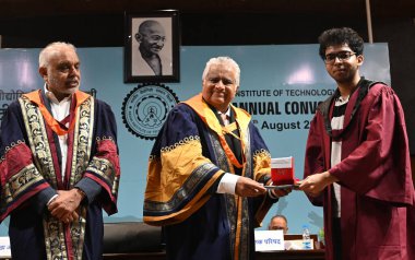 NEW DELHI, INDIA - AUGUST 10: Newly Graduated students from IIT Delhi receives their degrees by Harish Salve, King's Counsel and Sr. Advocate Chairperson Broad of Governors IIT Delhi, and Founder and Co-Chairman, Jubilant Bhartia Group  clipart