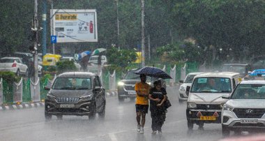 NEW DELHI, INDIA - JULY 10: Commuters seen during heavy rain at ITO Bahadur shah zafar on July 10, 2023 in New Delhi, India. Several parts of northwest India witnessed a heavy spell of rain breaking a 40-year-old record clipart