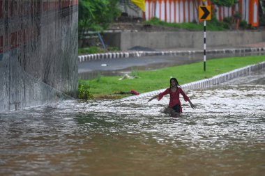 NEW DELHI, INDIA - 9 Temmuz 2023 'te Hindistan' ın Yeni Delhi kentinde muson yağmurları sonrasında ağır su tutulan Bhairav Marg alt geçidinden hareket ederler. Delhi-NCR, Cuma, Cumartesi ve Pazar gecelerinde şiddetli yağmurdan sırılsıklam olmuştu. Şey...