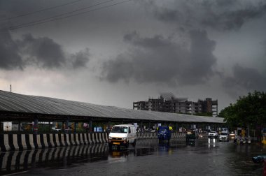 GURUGRAM, INDIA - 4 Temmuz 2023 tarihinde Hindistan 'ın Gurugram kentinde, Mini Secretariat yakınlarındaki Rajiv chowk' ta sağanak yağmur sırasında gökyüzünde kara muson bulutları