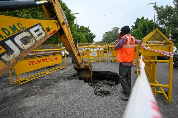 stock image NEW DELHI, INDIA - JULY 11: A part of the road gets caved in after Rains at C Hexagon near India Gate on July 11, 2023 in New Delhi, India. Several parts of northwest India witnessed a heavy spell of rain breaking a 40-year-old record. 