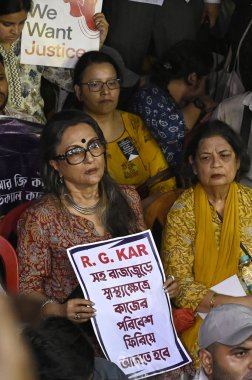 KOLKATA, INDIA - AUGUST 13: Film director Aparna Sen along with educationists, intellectuals express solidarity with agitating doctors and medical professionals over alleged rape and murder of PGT woman doctor  on August 13, 2024 in Kolkata, India clipart