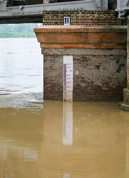 stock image NEW DELHI, INDIA - AUGUST 14: Flooded Yamuna River seen flows under the Iron Bridge in the afternoon  on August 14, 2024 in New Delhi, India. The water level of the river has touched 204.35 metre at the Old Railway Bridge (ORB). The warning level is