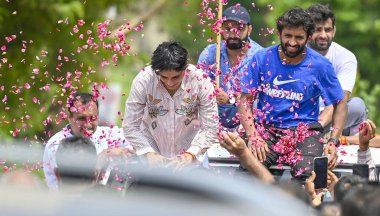 Supporters welcome with flowers to Wrestler Vinesh Phogat upon her arrival at IGI airport to her village in at Dawarka Express way on August 17, 2024 in New Delhi, India. clipart