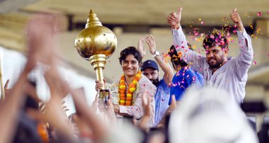 Supporters welcome with flowers to Wrestler Vinesh Phogat upon her arrival at IGI airport to her village in at Dawarka Express way on August 17, 2024 in New Delhi, India. clipart