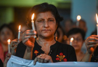 Members of the Noida Bengali Cultural Association (NBCA) staged a candlelight protest at Noida Kali Bari Sector 26 on Wednesday night against alleged sexual assault and murder of  intern doctor at Kolkatas RG Kar Medical College, on August 15, 2024 clipart