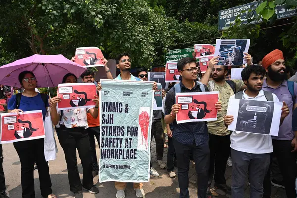 stock image NEW DELHI, INDIA - AUGUST 21: Practicing doctors and medical staff display placards as they take part in a protest against the incident of rape and murder of a young medic in Kolkata, during a demonstration held at Jantar Mantar  on August 21, 2024 