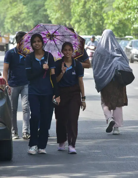 stock image GHAZIABAD INDIA - MAY 31: People seen out during an extremely hot day on May 31 2024 in Ghaziabad India. Delhi and the national capital region which includes Gurgaon Noida Faridabad Ghaziabad and more satellite towns have been reeling under a severe 