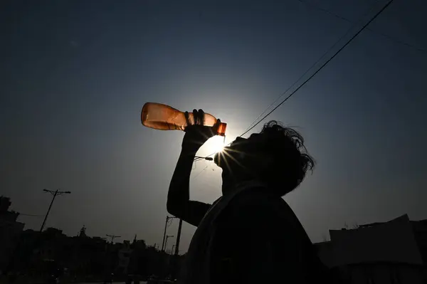 stock image NEW DELHI INDIA - MAY 31: A person drinks water amid extreme Hot weather on May 31 2024 in New Delhi India. Delhi and the national capital region which includes Gurgaon Noida Faridabad Ghaziabad and more satellite towns have been reeling under a seve