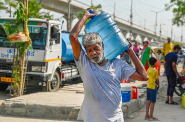 NEW DELHI  INDIA - JUNE 3  2024  People are filling water from a supply water tanker of Delhi Government  during a high temperature heat wave  at New Ashok Nagar area  on June 3  2024 in New Delhi  India. Several areas in Delhi including Chanakyapuri clipart