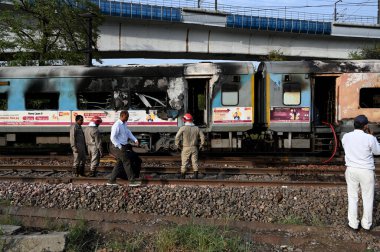 NEW DELHI  INDIA - JUNE 3  2024  Firefighters and passengers on tracks after a fire broke out in the Taj Express  near Sarita Vihar  on June 3  2024 in New Delhi  India. The blaze broke out between the Okhla and Tughlakabad railway stations. The trai clipart