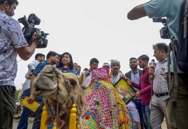 NEW DELHI INDIA JUNE 25 2024 Bharat Adivasi Party MP from Banswara Rajkumar Roat riding a camel headed to Parliament for his oathtaking ceremony at the inaugural session of the 18th Lok Sabha However police halted him before reaching Parliament on Ju clipart