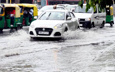 NEW DELHI INDIA JUNE 27 2024 Vehicles wades through logged rain water at ITO on June 27 2024 in New Delhi India The India Meteorological Department IMD has predicted the arrival of monsoon over large parts of northwest India over the next three to fo clipart