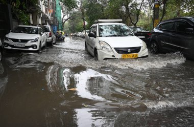 NEW DELHI INDIA JUNE 28 2024 Commuters wade through water logging at Dabri Gurugram road Dwarka on June 28 2024 in New Delhi India Indias national capital Delhi received its heaviest rain for the month of June in 88 years with roads being flooded clipart