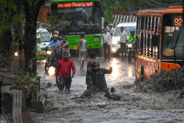 stock image NEW DELHI INDIA JUNE 28 2024 Commuters wade through water logging at Dabri Gurugram road Dwarka on June 28 2024 in New Delhi India Indias national capital Delhi received its heaviest rain for the month of June in 88 years with roads being flooded