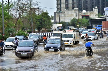 GHAZIABAD INDIA JUNE 29 2024 Commuters wade through a waterlogged road during monsoon rainfall at Pandav Nagar on June 29 2024 in Ghaziabad India The India Meteorological Department IMD predicts heavy to very heavy rainfall in Delhi over the next two clipart