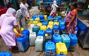 NEW DELHI, INDIA - JUNE 5 2024 People filling empty containers from a water tanker at Kusumpur Pahari near Vasant Vihar, on June 5, 2024 in New Delhi, India. Several areas in Delhi including Chanakyapuri's Sanjay Camp area and the Geeta colony area a clipart