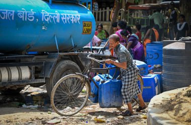 NEW DELHI, INDIA - JUNE 6 2024 People fill water from a Delhi Jal Board Tanker amid water scarcity at Anand Parbat on June 6, 2024 in New Delhi, India. (Photo by Sanchit Khanna/Hindustan Times) clipart