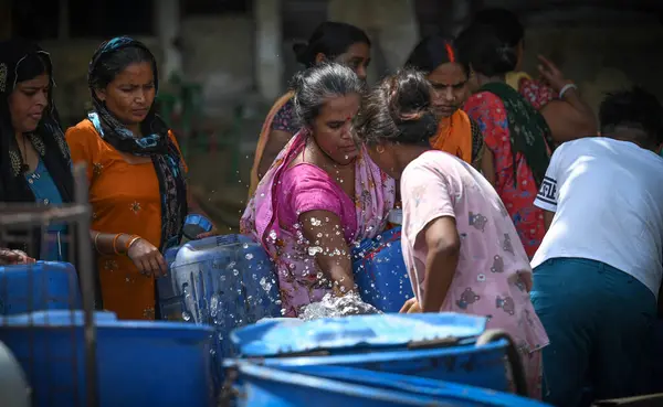 Stock image NEW DELHI, INDIA - JUNE 6 2024 People fill water from a Delhi Jal Board Tanker amid water scarcity at Anand Parbat on June 6, 2024 in New Delhi, India. (Photo by Sanchit Khanna/Hindustan Times)