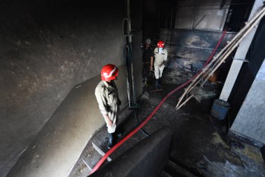 NEW DELHI, INDIA JUNE 8 2024   A view of fire fighters trying to douse the fire that broke out in split pulses factory early morning in Narela industrial area H block, on June 8, 2024 in New Delhi, India. At least three workers were killed while six  clipart