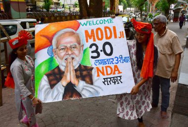 MUMBAI, INDIA JUNE 8 2024   Students of Gurukul School of Art draw portraits of Narendra Modi and other political leaders ahead of Narendra Modi's 3.0 oath-taking ceremony as India's prime minister tomorrow, at Lalbaug, on June 8, 2024 in Mumbai, Ind clipart