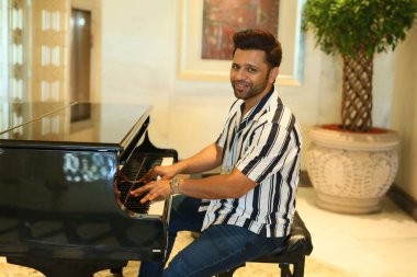 NEW DELHI, INDIA JUNE 8 2024    Bollywood singer Rahul Vaidya poses  on World Music Day special shoot, on June 8, 2024 in New Delhi, India. singer Rahul Vaidya settles in to reflect on his journey as a solo artist and the role music plays in his life clipart