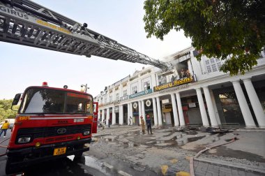 NEW DELHI, INDIA JUNE 9 2024   Firefighters try to douse a fire that broke out at the Mystery Rooms, a theme-based adventure game zone, at Connaught Place, on June 9, 2024 in New Delhi, India. The cause of the fire has yet to be determined. More deta clipart