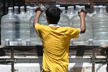 NEW DELHI INDIA JUNE 12 2024   Water suppliers distributing water can at Shaheen Bagh Delhi is facing severe heatwave during the ongoing hot summer weather on June 12 2024 in New Delhi India.  Photo by Salman Ali/Hindustan Times  clipart