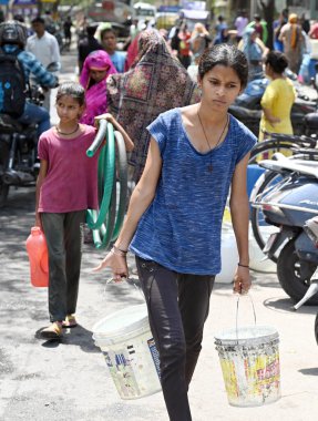 NEW DELHI INDIA JUNE 12 2024   Residents of Vivekanand Camp filling water from a water tanker supply at Chanakyapuri on June 12 2024 in New Delhi India.  Photo by Sanjeev Verma/Hindustan Times   clipart