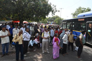 NEW DELHI INDIA 13 Haziran 2024 DTC Yolcuları sıcak bir yaz öğleden sonra Jawaharlal Nehru Marg 'da Yeni Delhi Tren İstasyonu' nun yanındaki Jawaharlal Nehru Marg 'da bir ağaç gölgesi altında duruyorlar. Fotoğraf: Sonu Mehta / Hindustan Times 