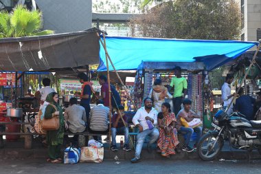 NEW DELHI INDIA JUNE 13 2024   DTC Passengers standing under a foot overbridge shadow on a hot summer afternoon at Minto Road  Near Ajmeri Gate side  New Delhi Railway Station on June 13 2024 in New Delhi India.  Photo by Sonu Mehta/Hindustan Times  clipart