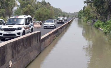 NEW DELHI INDIA JUNE 13 2024   Delhi police officials Patrolling along Munak canal Bawana JJ Colony to Harevali on June 13 2024 in New Delhi India. The deployment of police personnel along the canal comes after the Supreme Court on Wednesday drew a d clipart